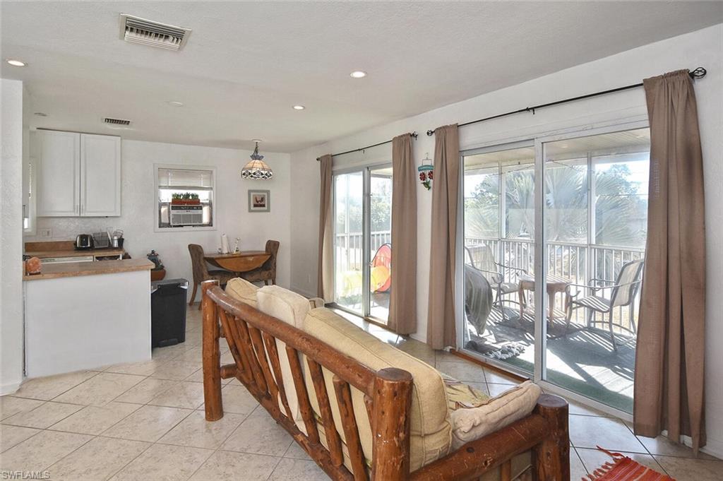 Dining room featuring light tile patterned floors and recessed lighting