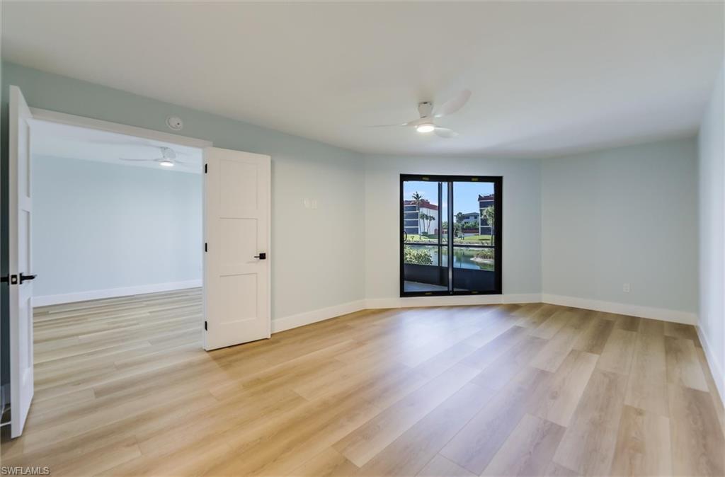 Spare room featuring a ceiling fan and light wood-type flooring