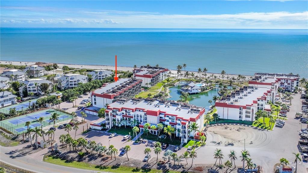 Bird's eye view of apartment complex and a nearby body of water