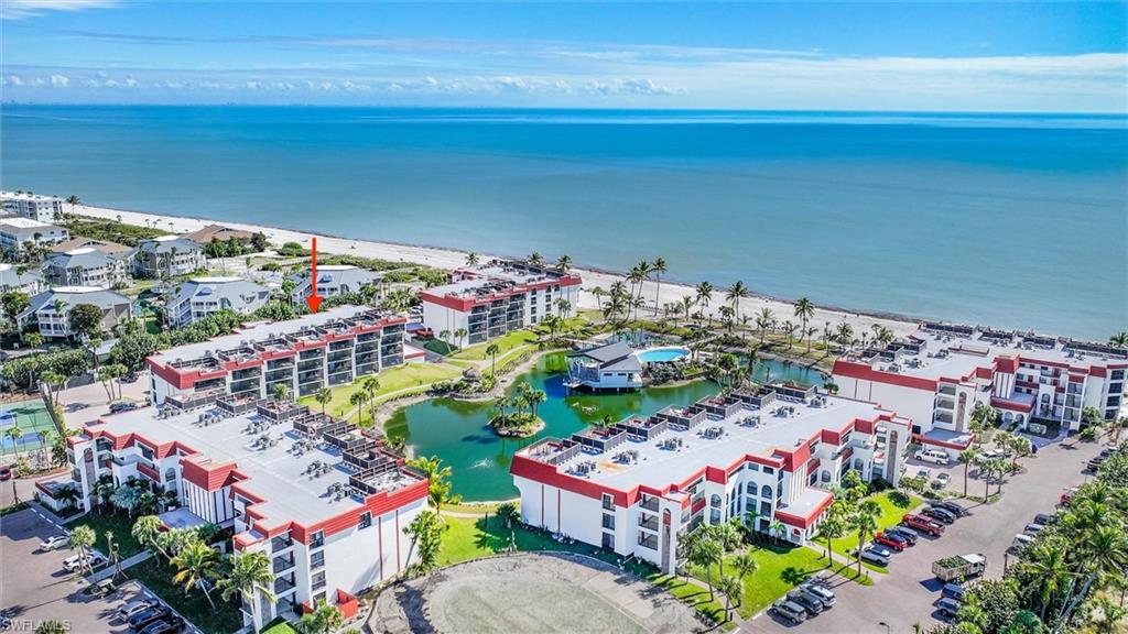 Drone / aerial view of apartment complex / building and a large body of water