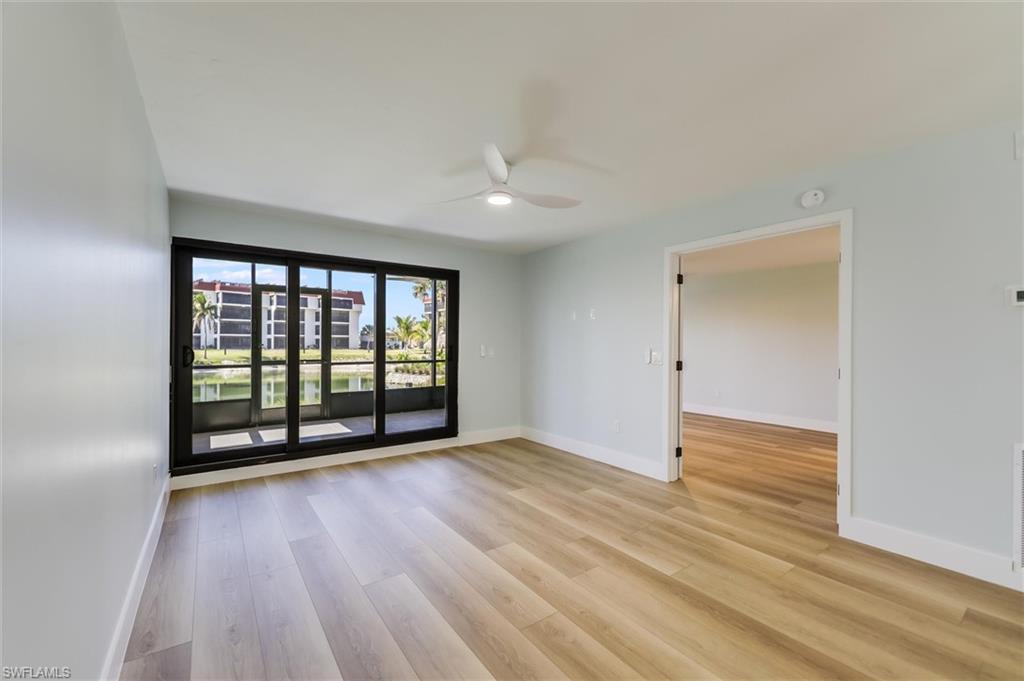 Empty room featuring light wood-style floors and ceiling fan