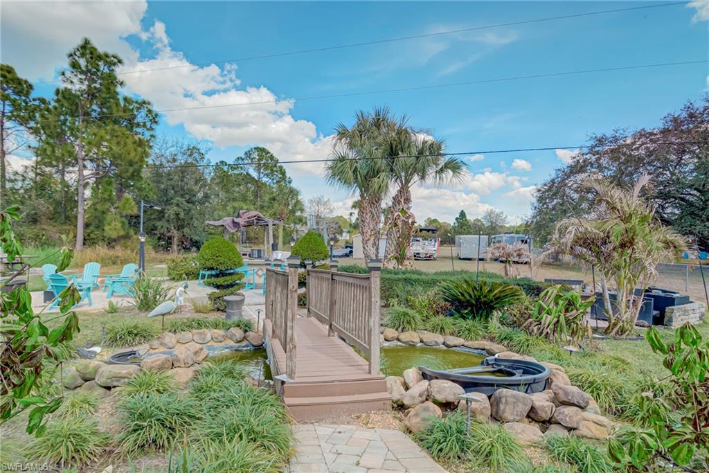 View of yard with a garden pond and a swimming pool