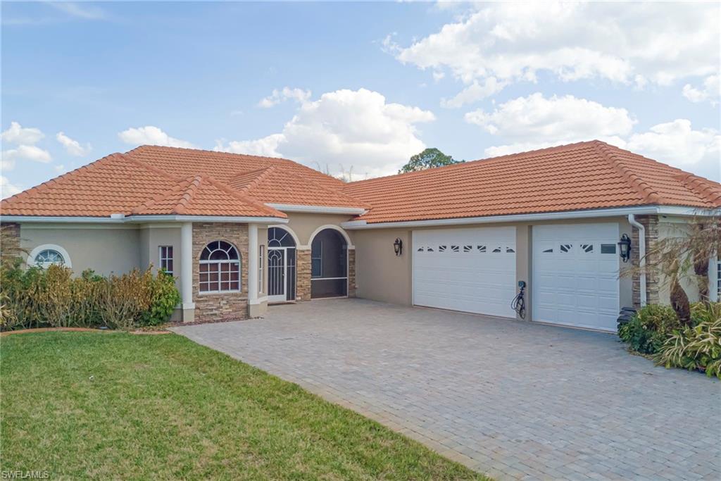 Mediterranean / spanish house featuring an attached garage, stucco siding, and a tile roof