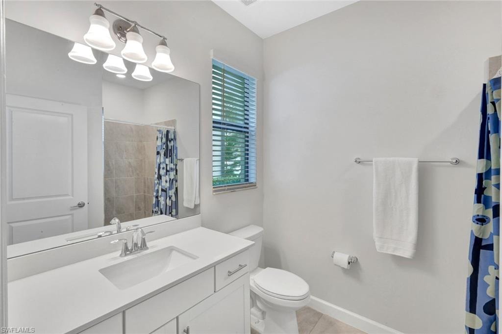 Bathroom featuring vanity and a shower with shower curtain