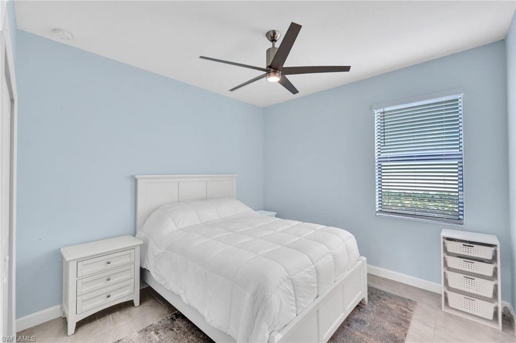 Bedroom with baseboards and a ceiling fan