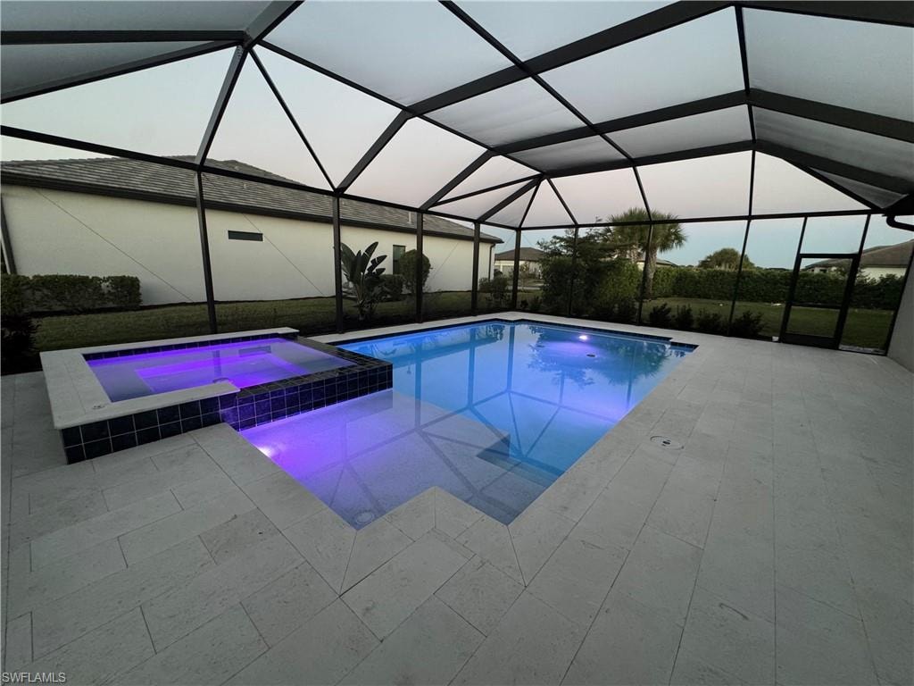Integrated pool / hot tub featuring a sunroom, a lanai, and a patio area