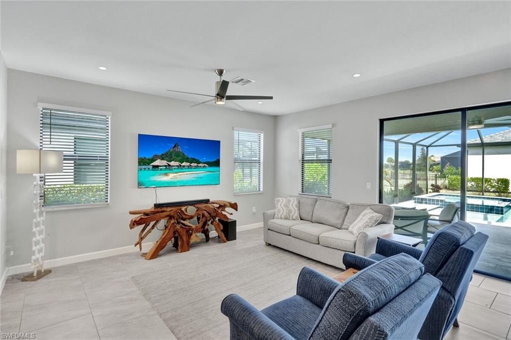 Living area with a ceiling fan, a sunroom, and recessed lighting