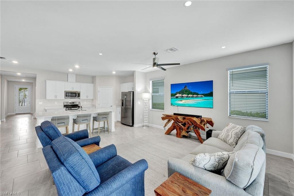Living room featuring recessed lighting and ceiling fan