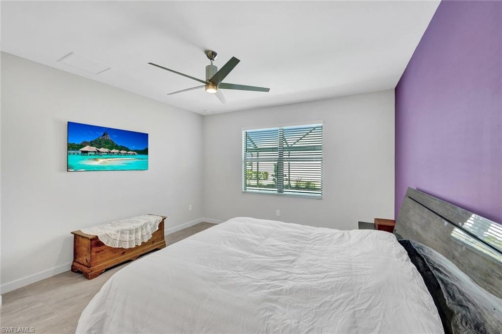 Bedroom featuring a ceiling fan and baseboards