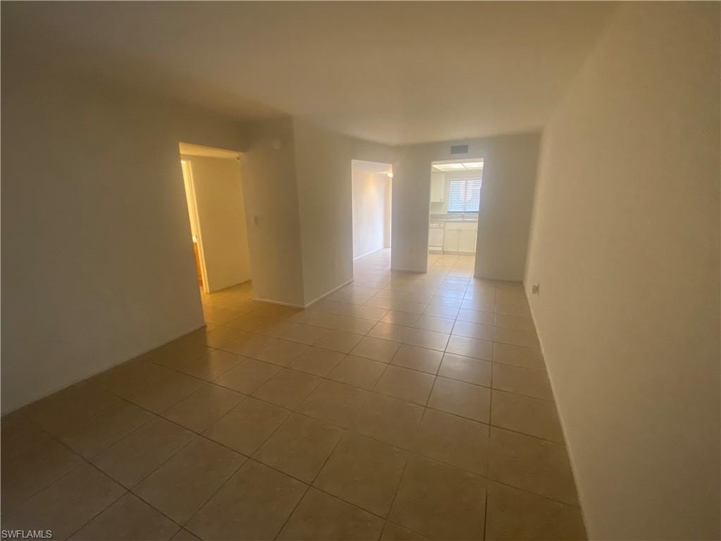 Unfurnished room with light tile patterned flooring