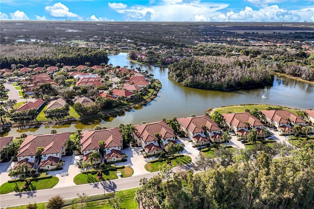 Aerial view of residential area featuring a nearby body of water