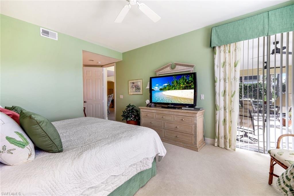 Primary Bedroom with access to outside, carpet, and a ceiling fan