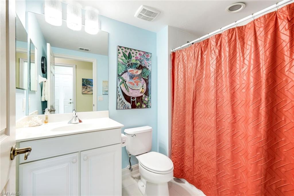 Guest Full bathroom featuring vanity, light tile patterned floors, and shower / tub combo with curtain