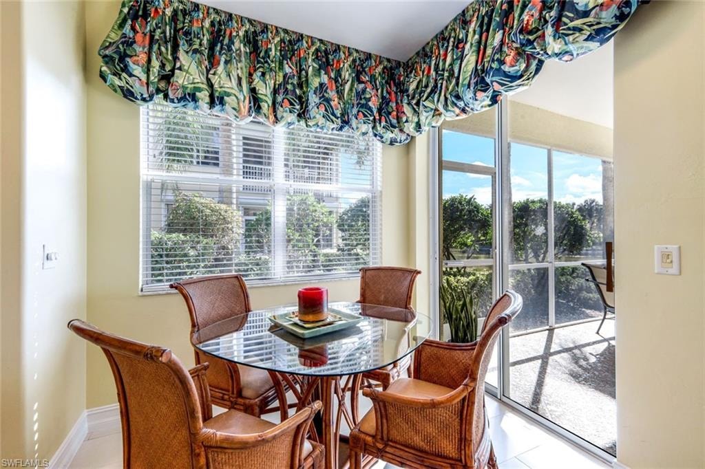 Dining area featuring tile patterned floors and baseboards