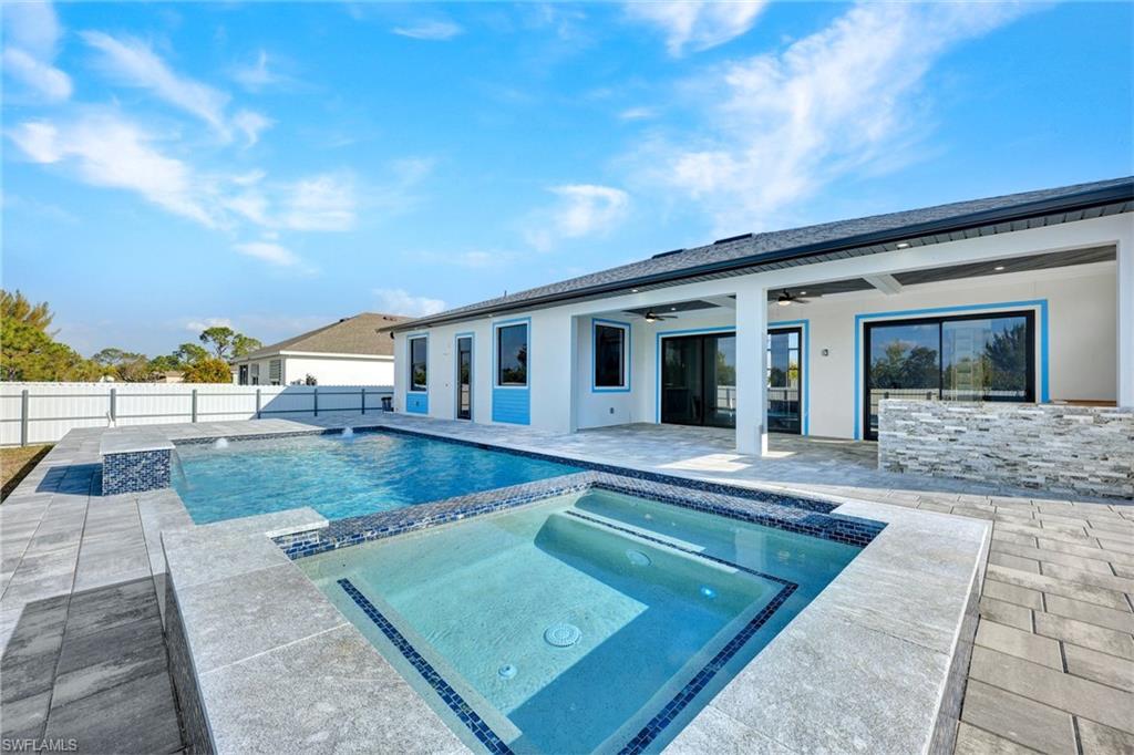 Integrated pool / hot tub featuring a patio area and a fenced backyard