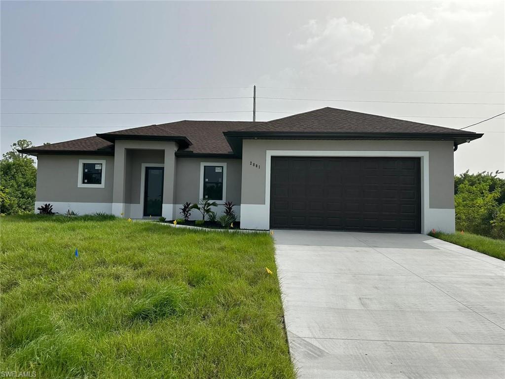 Prairie-style home featuring concrete driveway, an attached garage, and stucco siding
