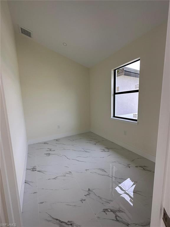 Empty room with light marble finish floors and baseboards