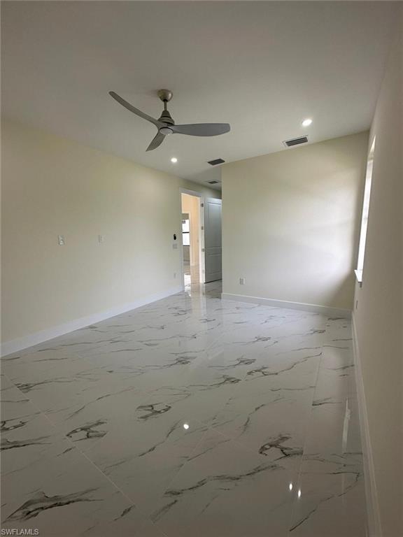 Unfurnished room with light marble finish flooring, recessed lighting, and a ceiling fan