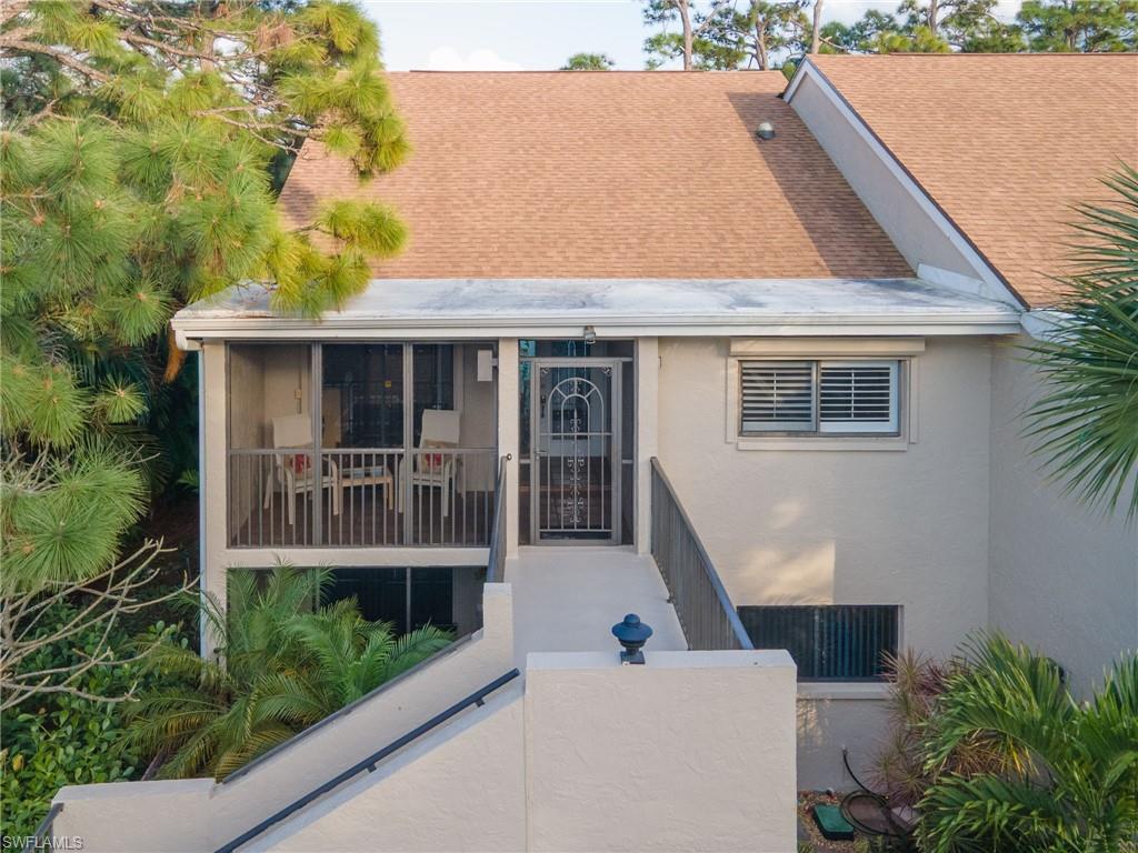 View of front of unit featuring catwalk and screened balcony