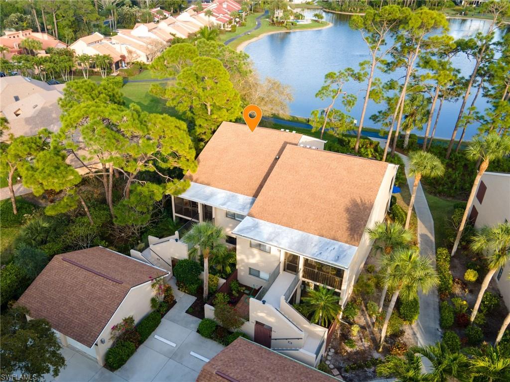 Aerial view unit with garage in front and lake behind