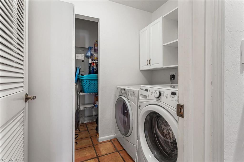 Laundry area features full-sized washer and dryer, in-wall safes, extra storage, and separate utility closet
