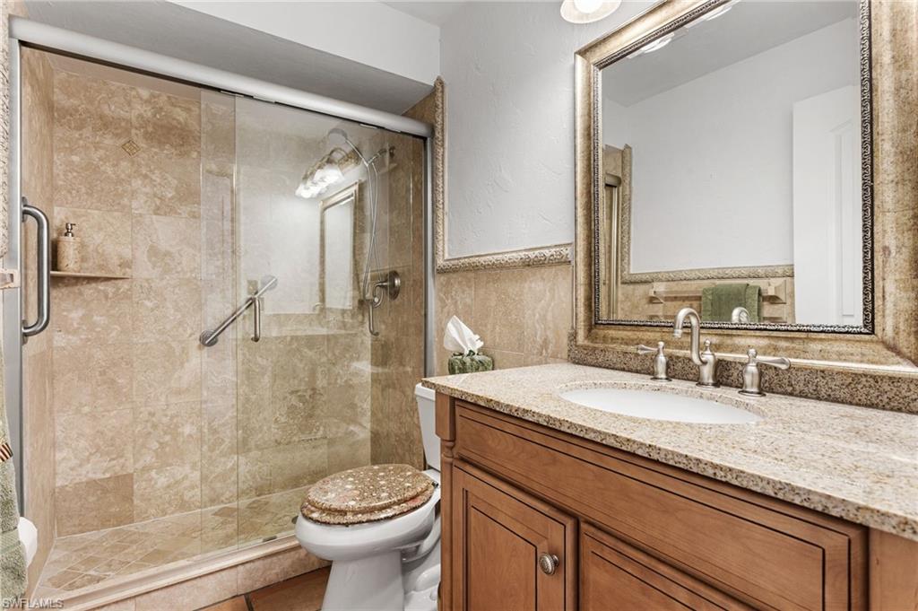 Guest bathroom features beautifully updated walk-in shower and counter-height vanity
