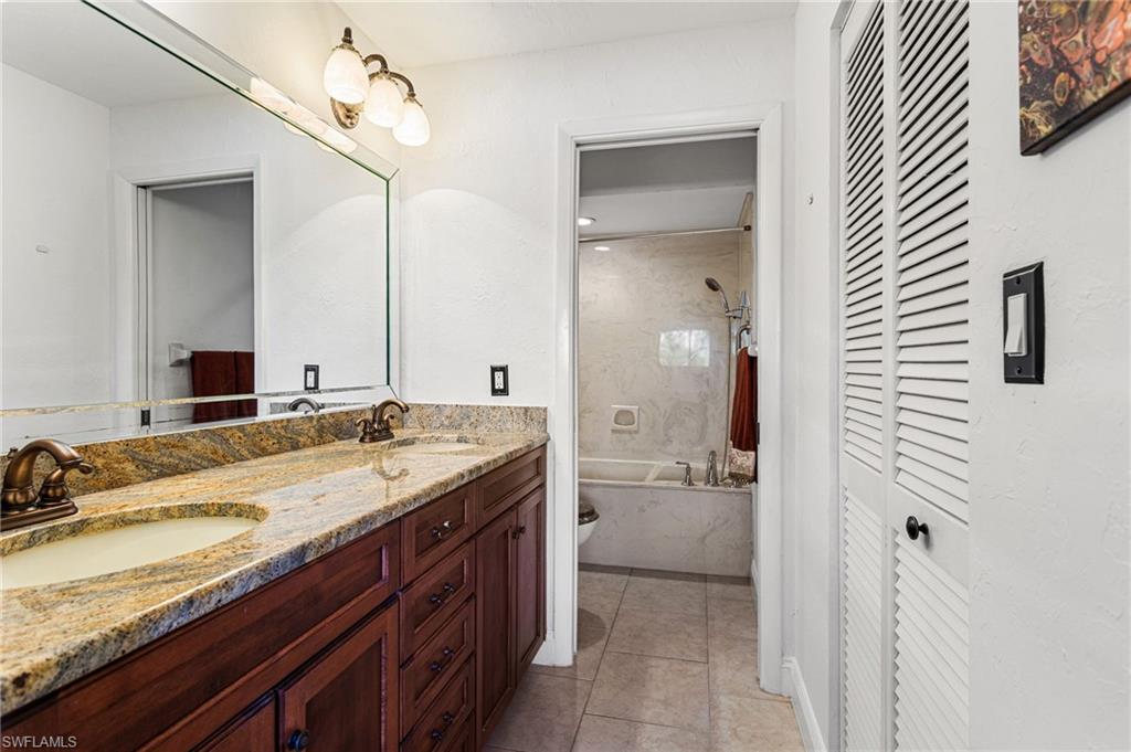 En suite includes walk-in closet, double counter-height vanity, and separate water closet with combined shower/soaking tub