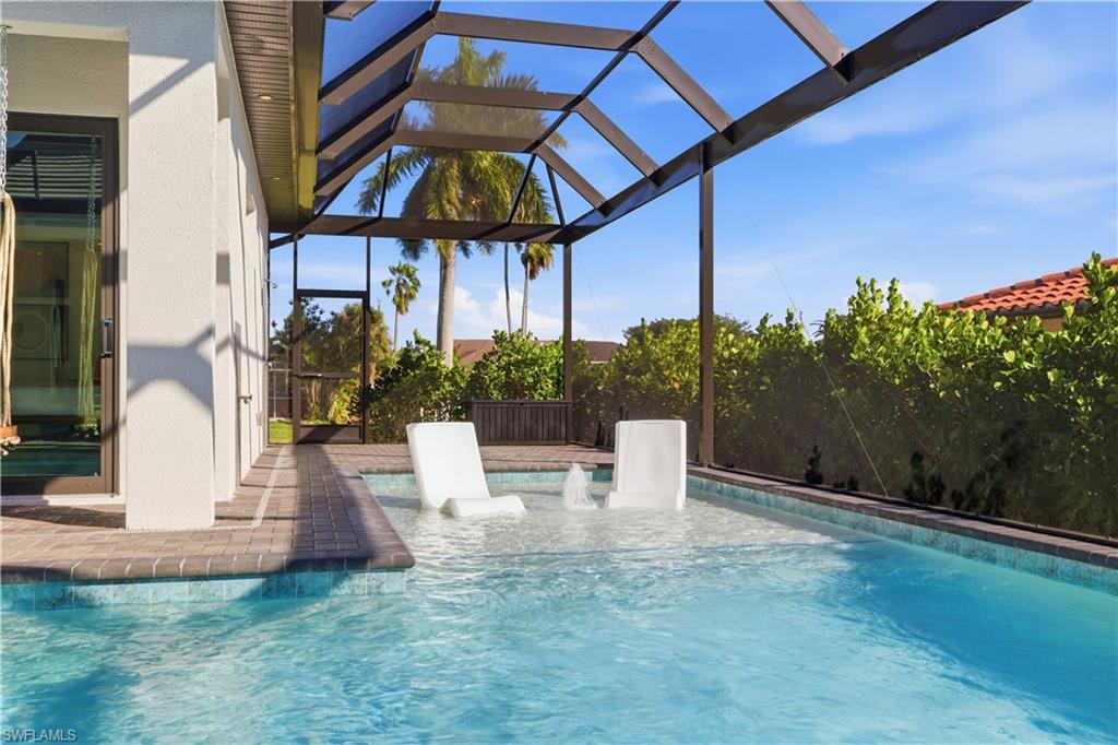 Outdoor pool with glass enclosure, a patio, a sunroom, and a pergola