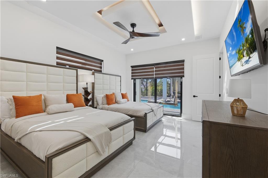 Bedroom with access to outside, a ceiling fan, and recessed lighting