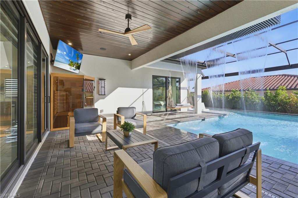 View of patio with a ceiling fan, an outdoor lounge area, and an outdoor pool