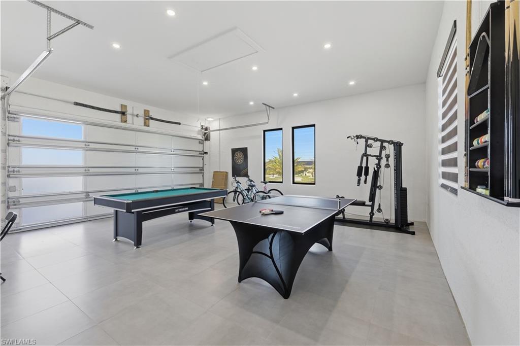 Recreation room featuring a garage, recessed lighting, and billiards