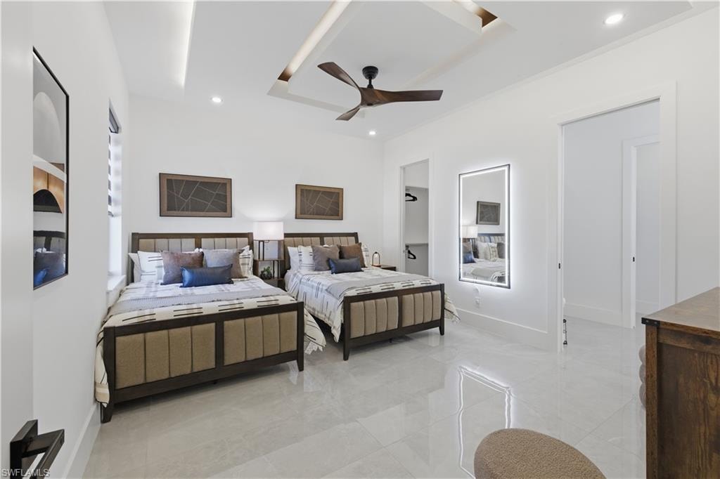 Bedroom with a ceiling fan and recessed lighting