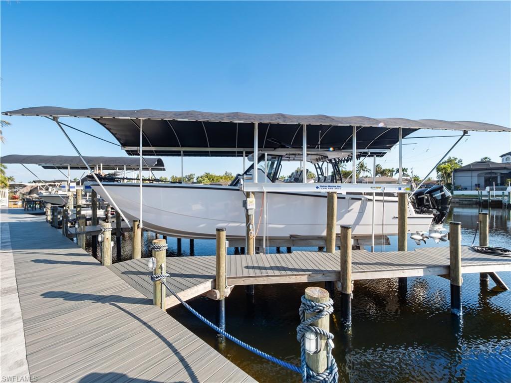 Dock area featuring boat lift and a water view