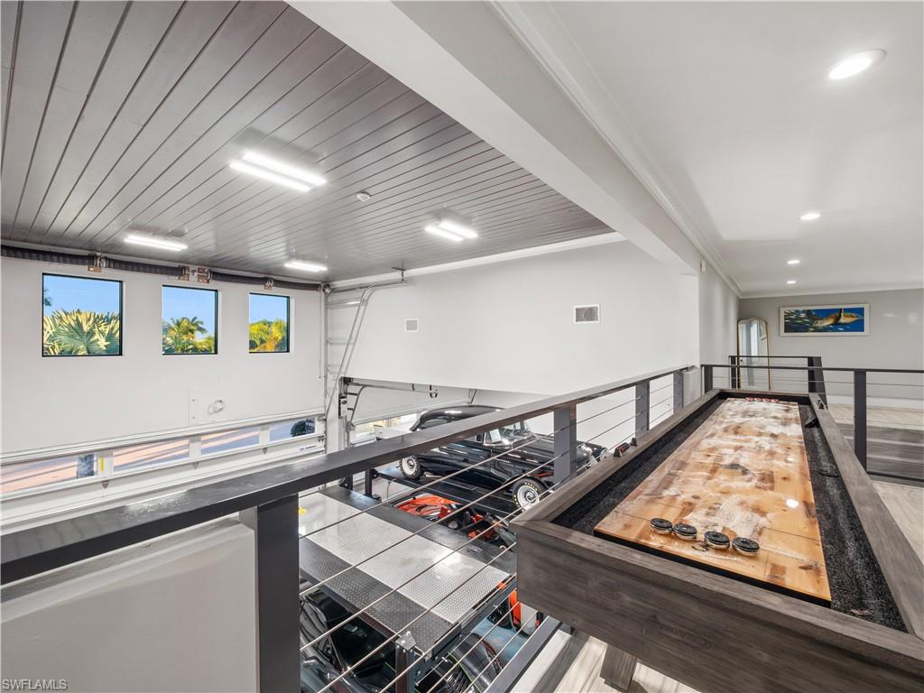 Recreation room featuring crown molding and wooden ceiling