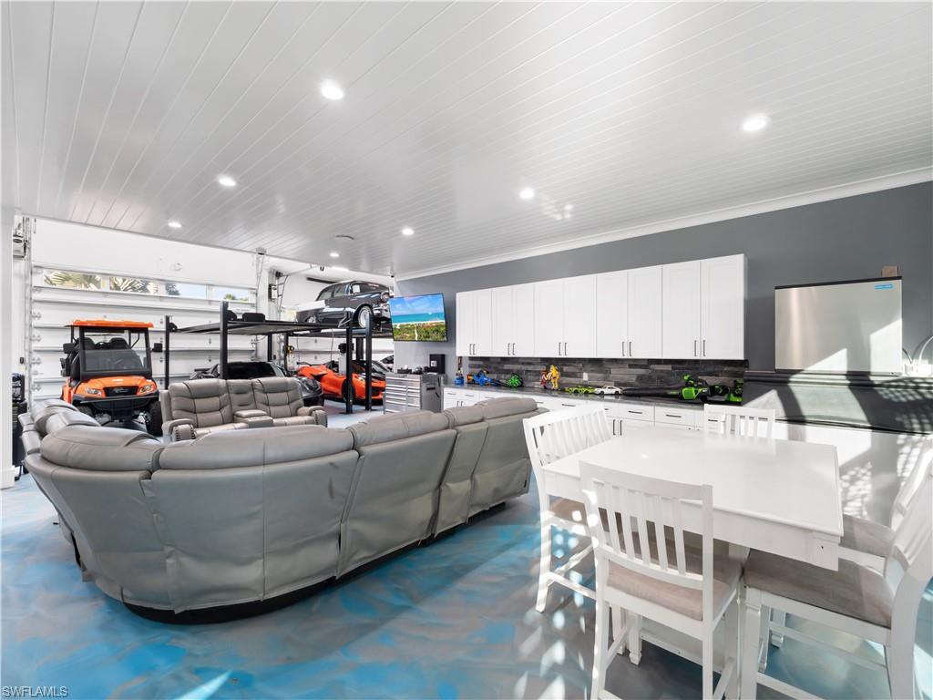 Living area featuring recessed lighting, wooden ceiling, and a garage