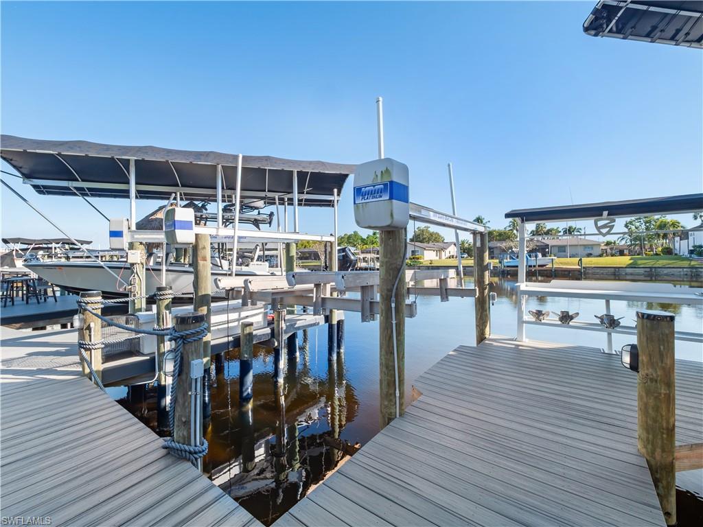 Dock with boat lift and a water view