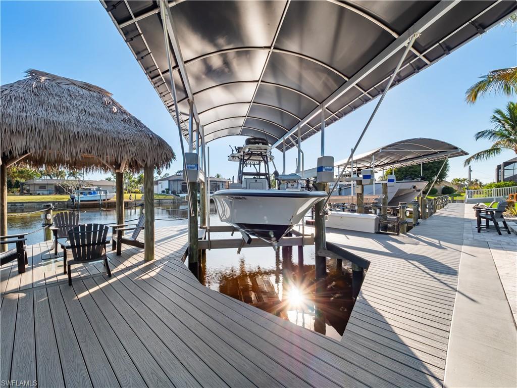 Dock area featuring boat lift and a water view