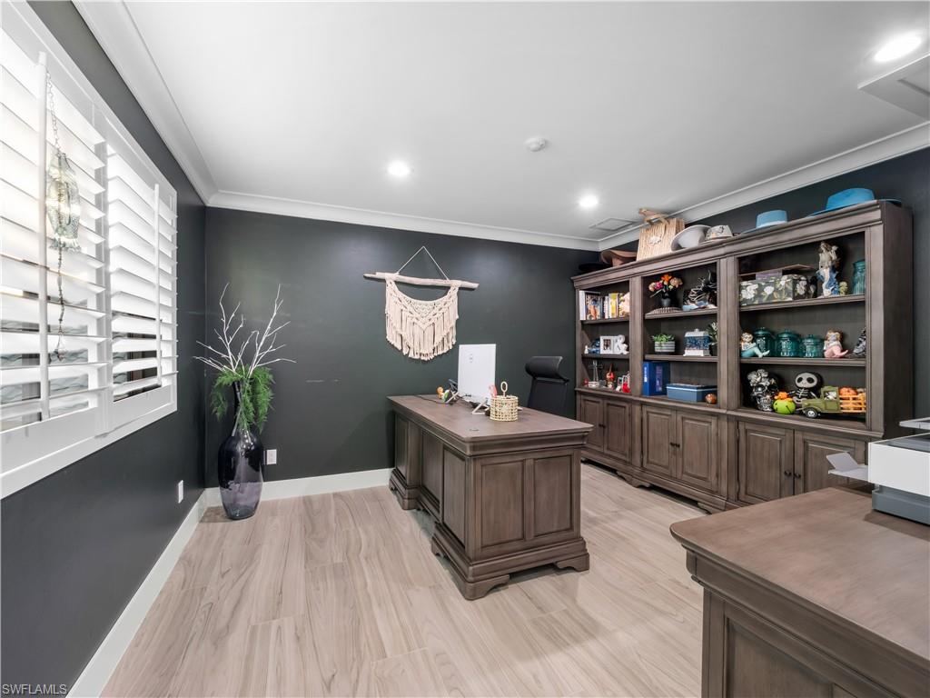 Office area with crown molding, light wood-style floors, and recessed lighting