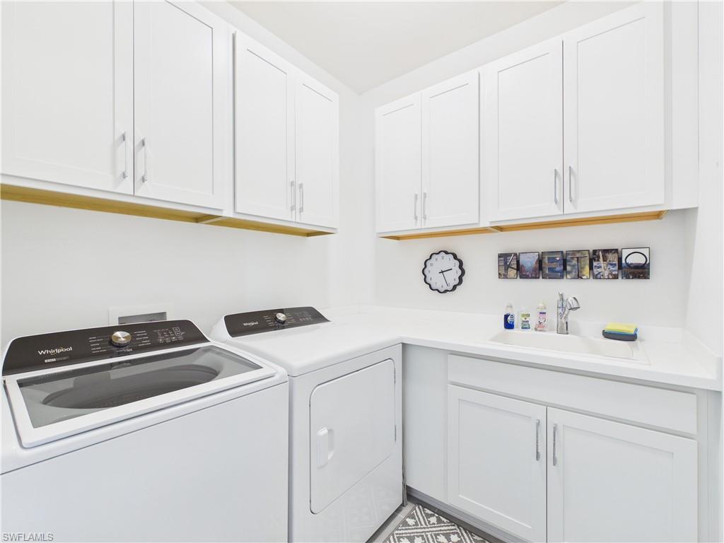 Laundry room with independent washer and dryer and cabinet space