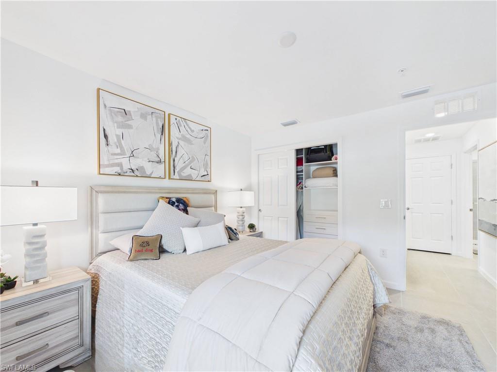 Bedroom with a closet and light tile patterned floors
