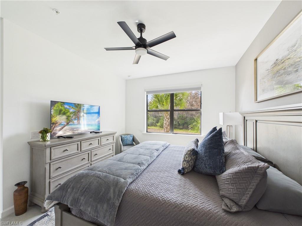 Bedroom with ceiling fan and carpet