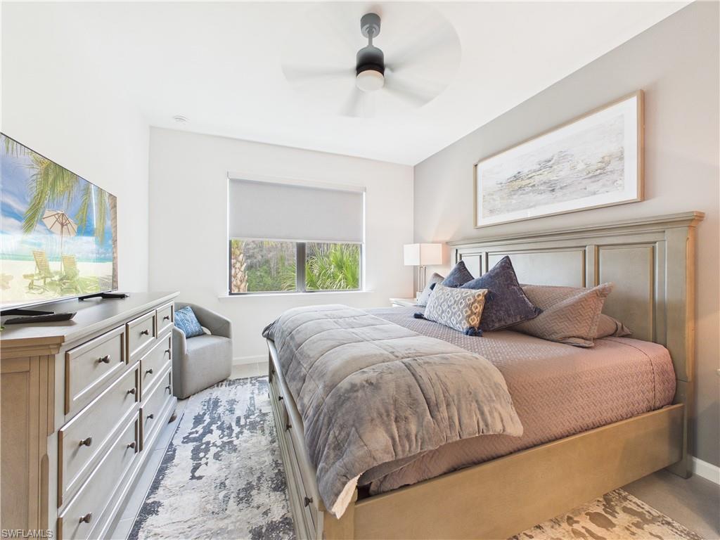 Bedroom featuring ceiling fan and baseboards