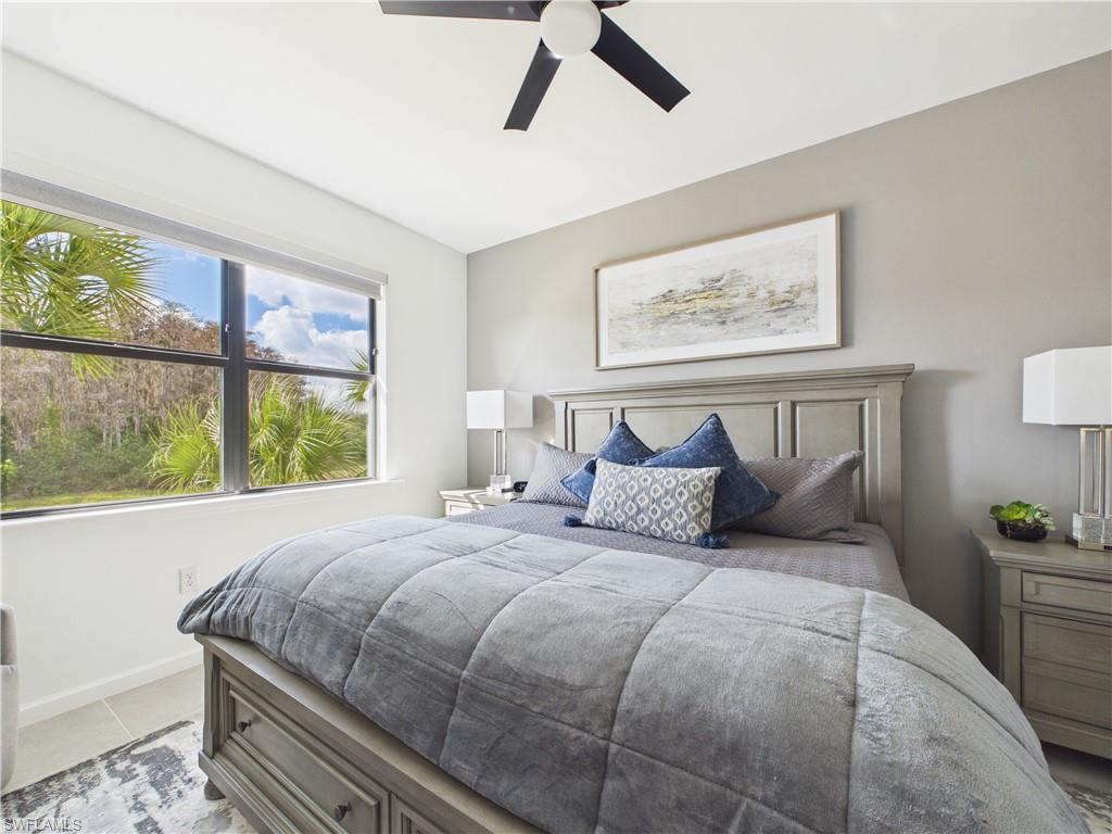 Bedroom with a ceiling fan and baseboards
