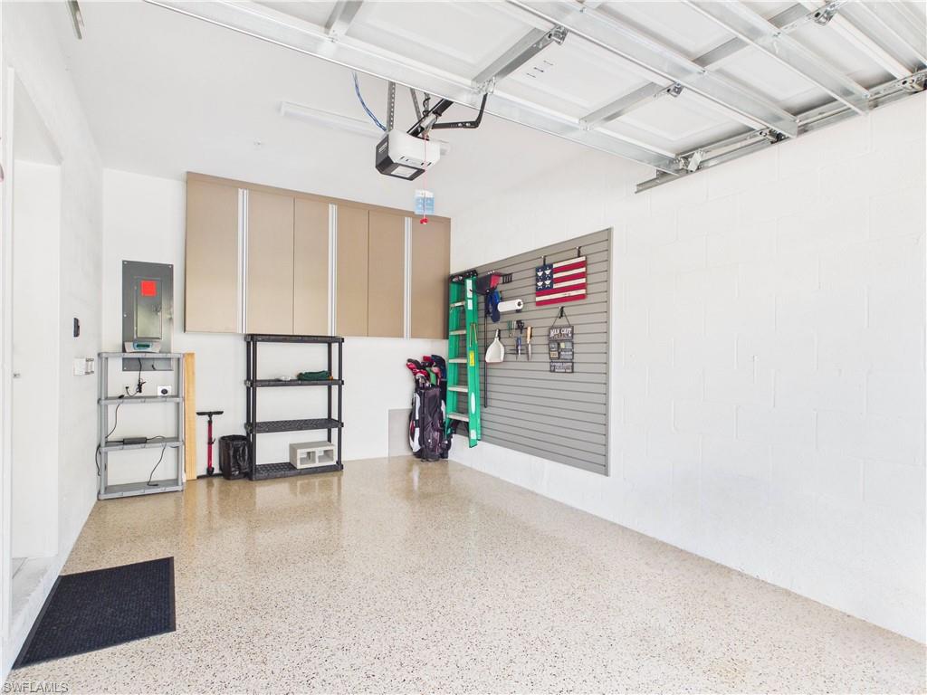 Garage with electric panel and a garage door opener