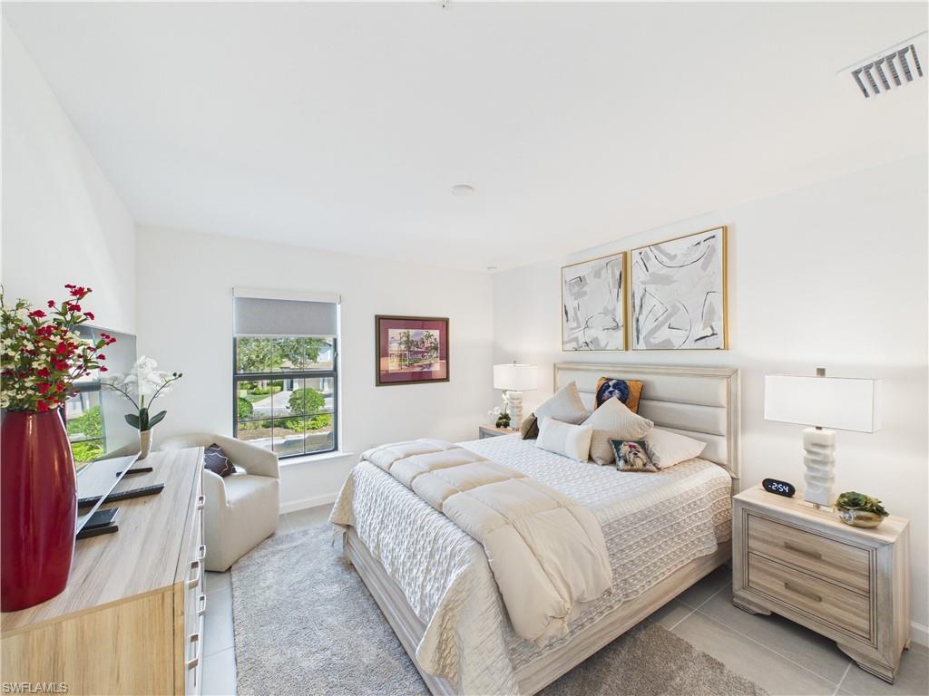 Bedroom with baseboards and light tile patterned floors