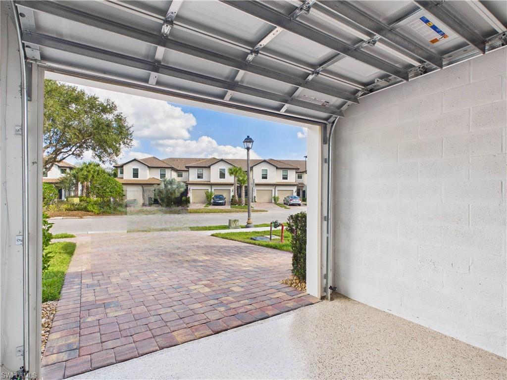 Garage featuring concrete block wall and a residential view