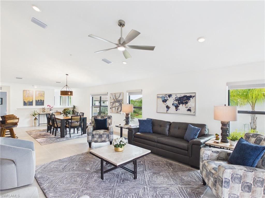 Tiled living area featuring ceiling fan and recessed lighting