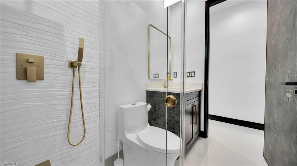 Full bathroom with vanity, a walk in shower, and light tile patterned floors