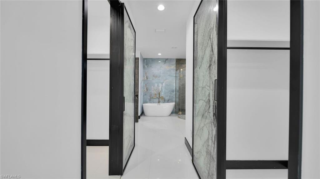 Full bathroom with recessed lighting and a freestanding bath