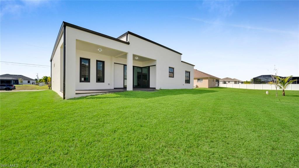 Rear view of property featuring a patio and stucco siding